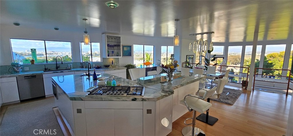 8109 Sinaloa Road Playa del Rey, CA 90293 - Photo 9 of 19 a view of a dining room with furniture large windows and wooden floor