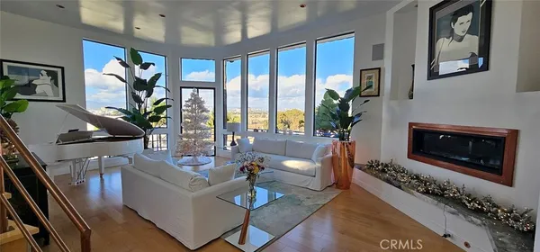 a living room with furniture large window and flat screen tv