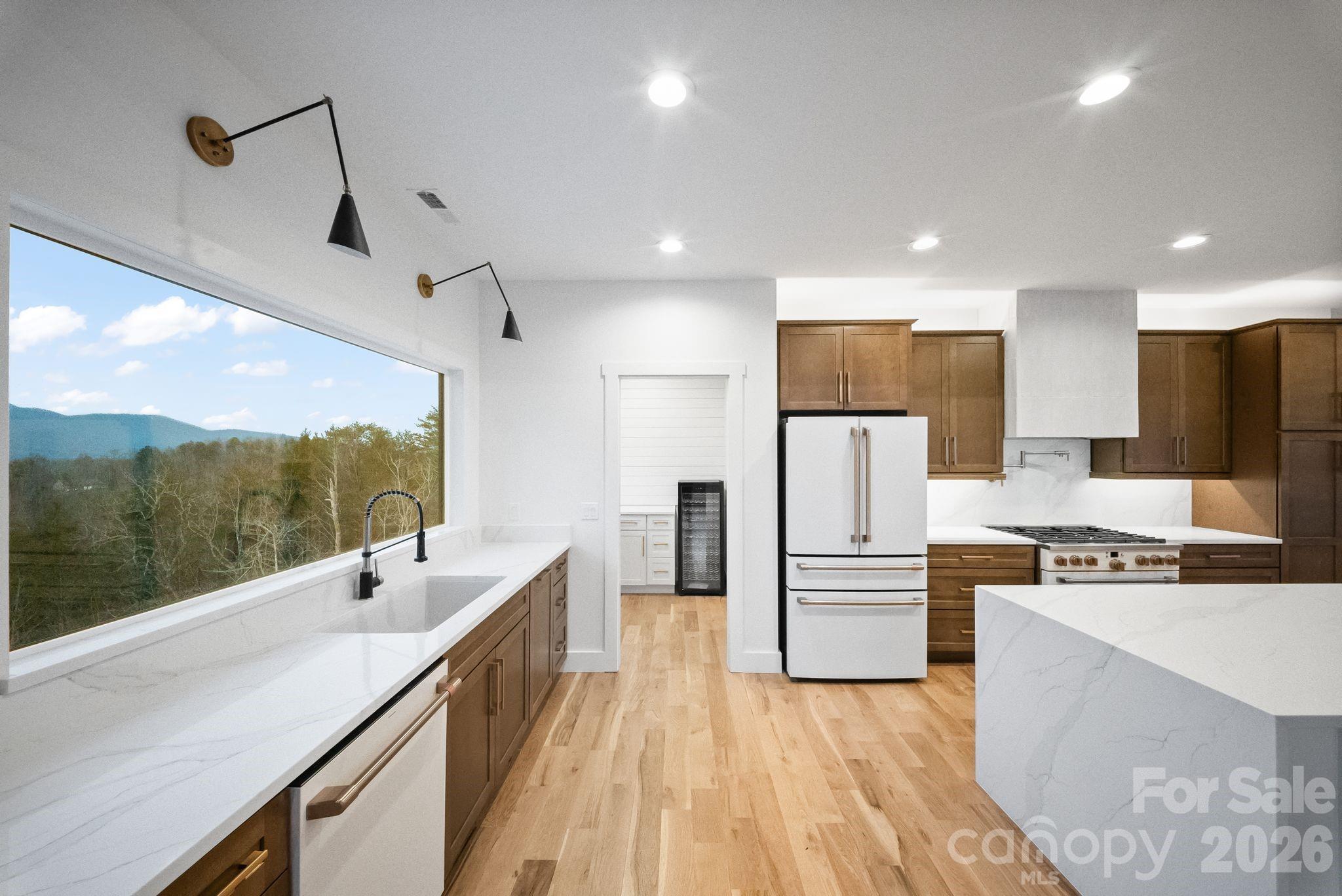 a kitchen with refrigerator cabinets and wooden floor