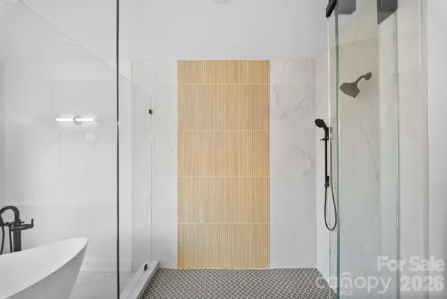 a bathroom with a shower and a sink