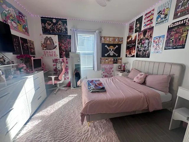 a bedroom with bed and wooden floor