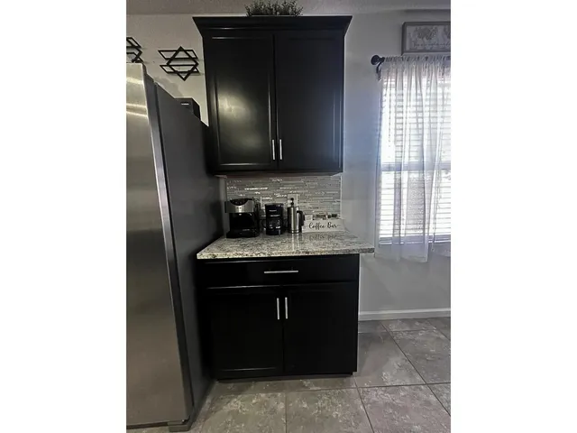 a kitchen with a sink and a mirror