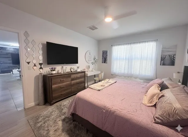 a bedroom with a bed and a flat screen tv