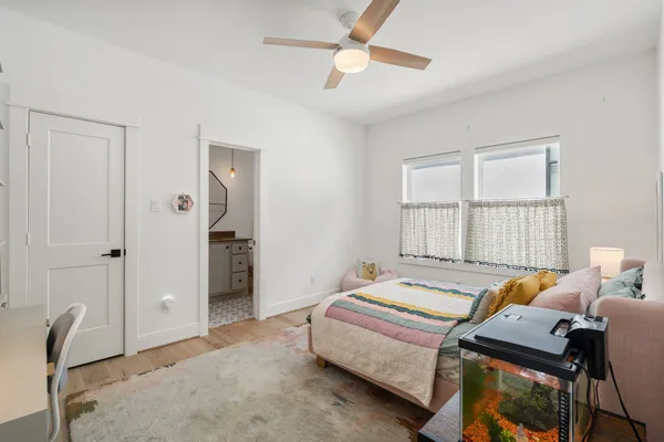 a bedroom with a bed and a chandelier