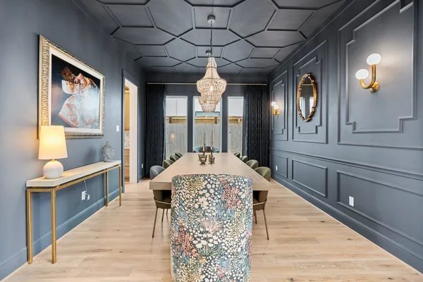 a kitchen with a table chairs stove and cabinets