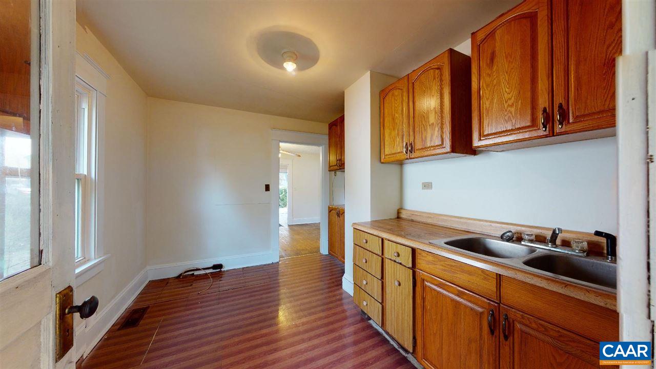 241 Shamrock Road Charlottesville, VA 22903 - Photo 12 of 24 a kitchen with stainless steel appliances granite countertop a sink and wooden cabinets
