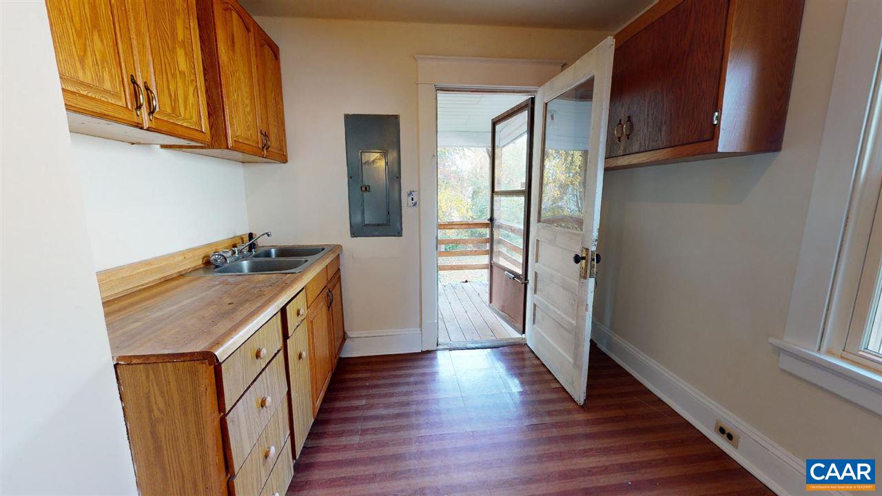 241 Shamrock Road Charlottesville, VA 22903 - Photo 4 of 24 a kitchen with a refrigerator a sink and wooden floor