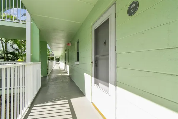 a view of a hallway view with wooden floor and staircase