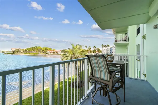 a bedroom with a bed a flat screen tv and dresser
