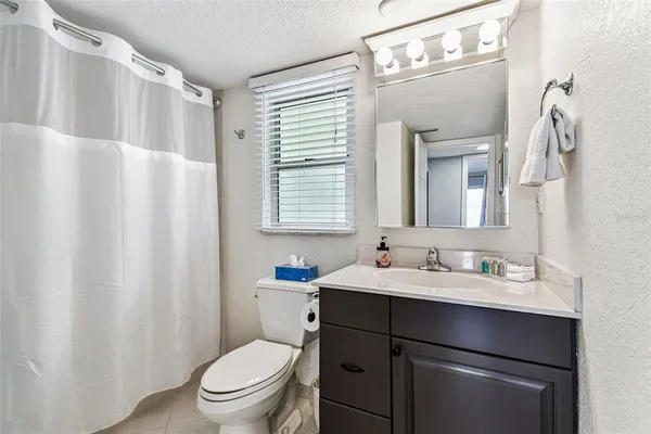 a bedroom with a large bed and a dresser