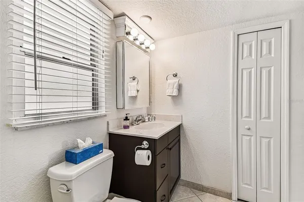 a large white kitchen with cabinets