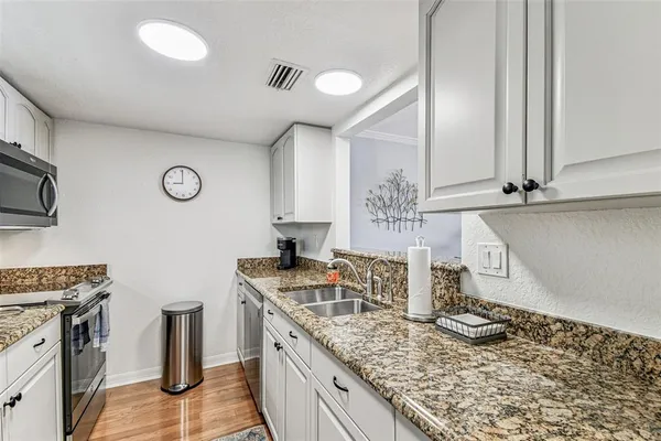 a kitchen with a sink and refrigerator