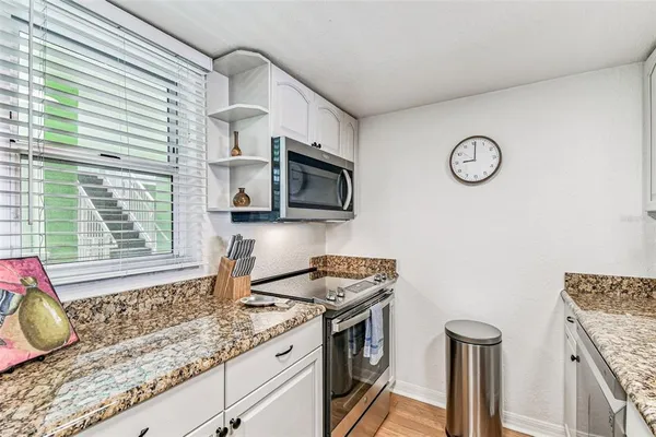 a kitchen with a refrigerator and a microwave