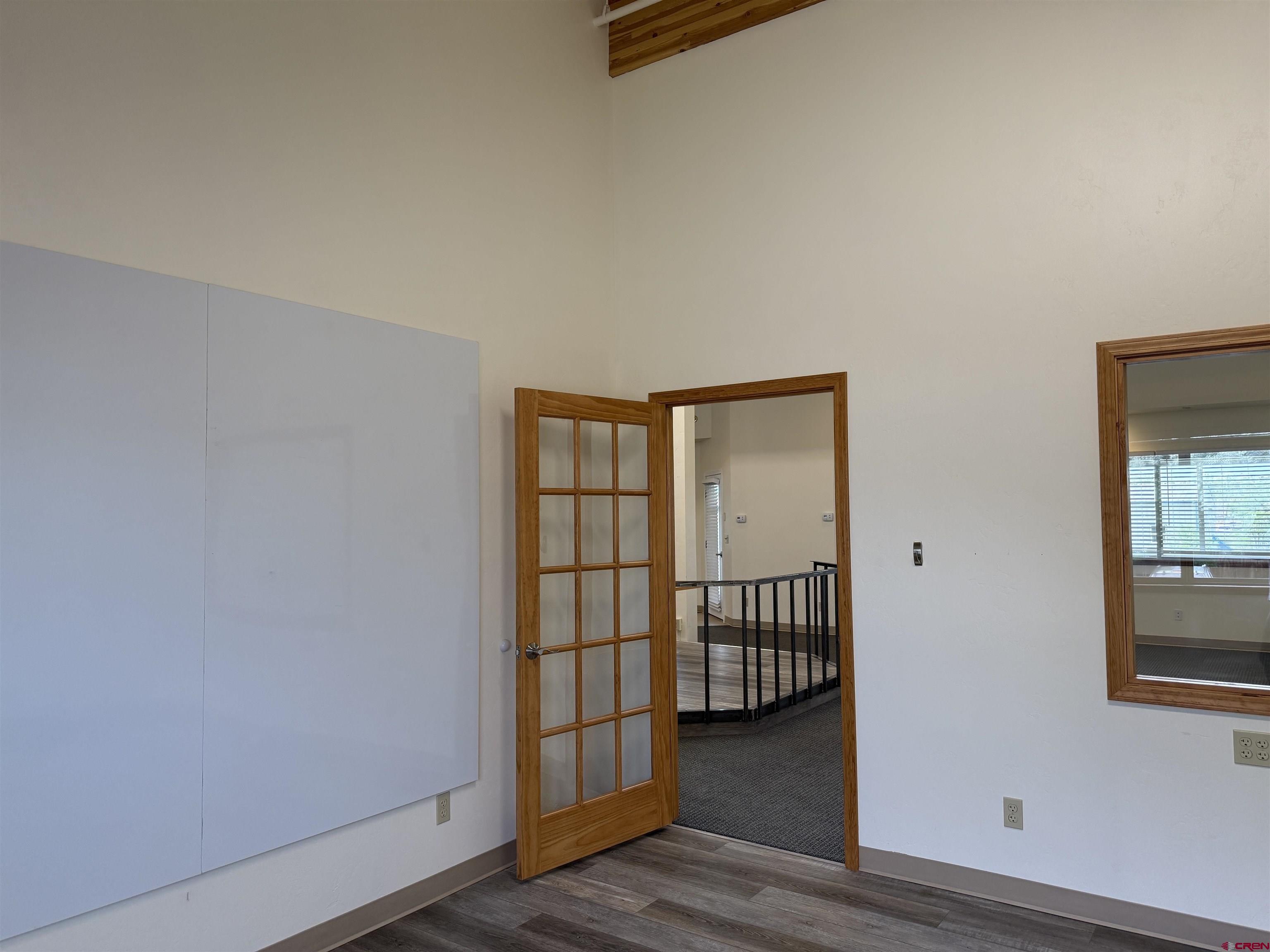 691 County Road 233, Unit B7 & B8 Durango, CO 81301 - Photo 17 of 31 an empty room with wooden floor and windows