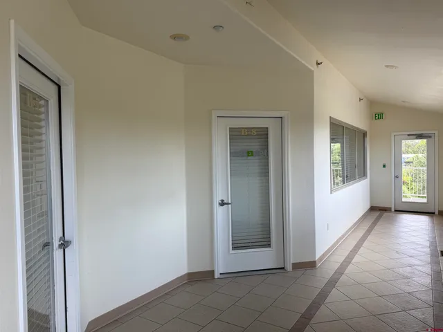 a backyard view of a patio with a table and chairs