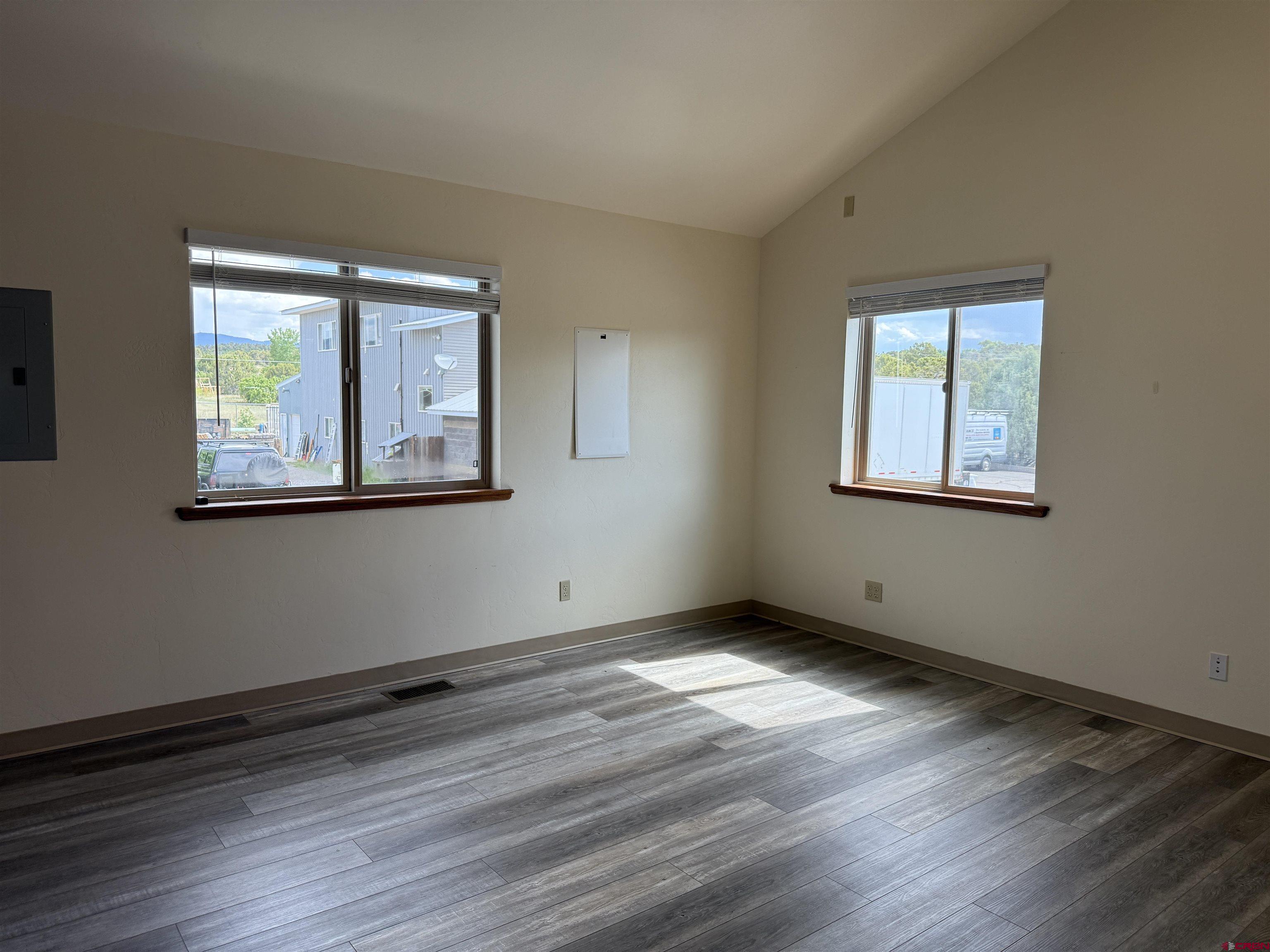 691 County Road 233, Unit B7 & B8 Durango, CO 81301 - Photo 7 of 31 a view of an empty room with wooden floor and a window