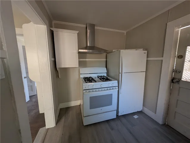 a kitchen with a refrigerator a stove top oven