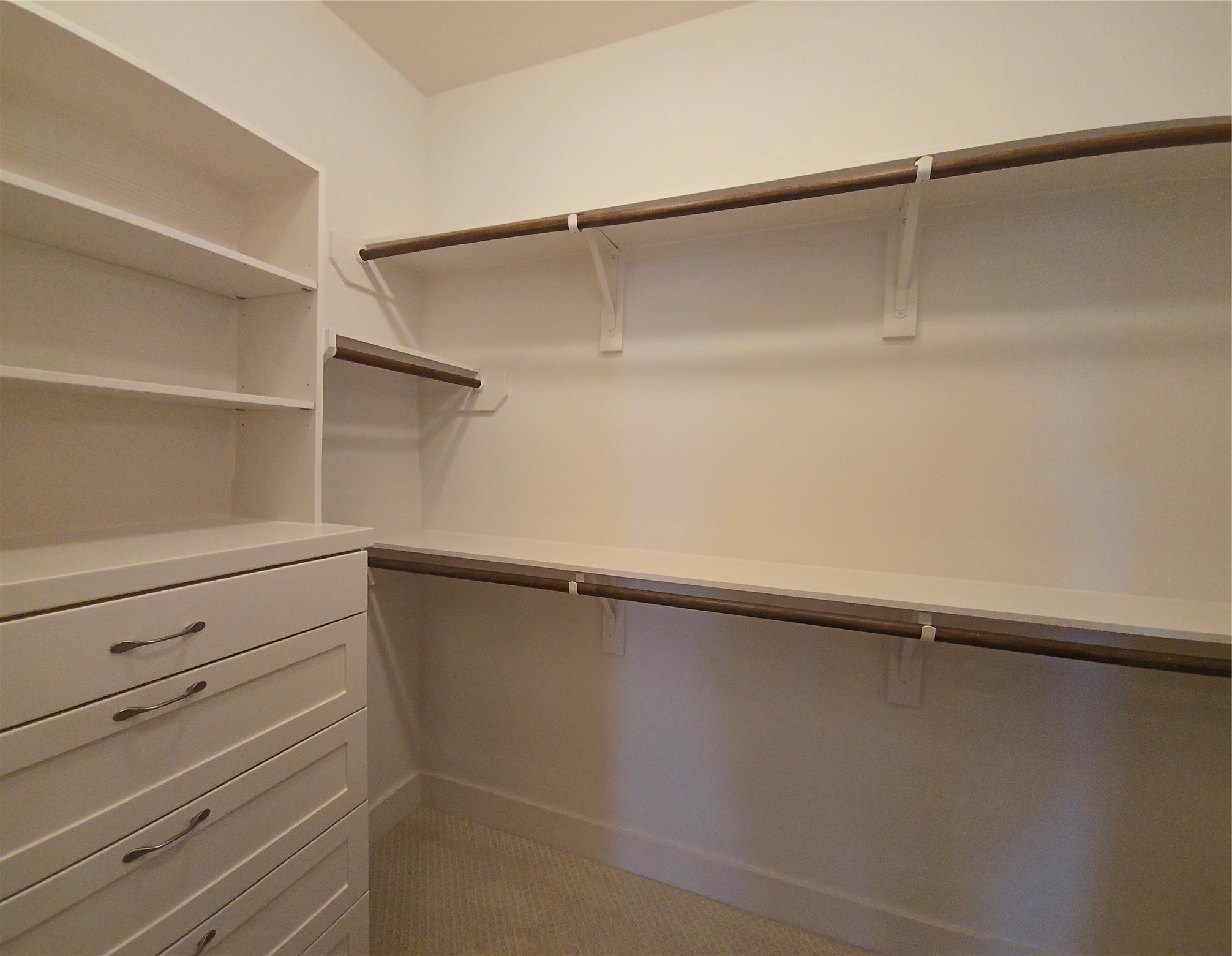 1117 Bonner Street Houston, TX 77007 - Photo 35 of 44 The primary bedroom walk-in closet offers multiple hanging racks and built-in shelves and drawers for storage.