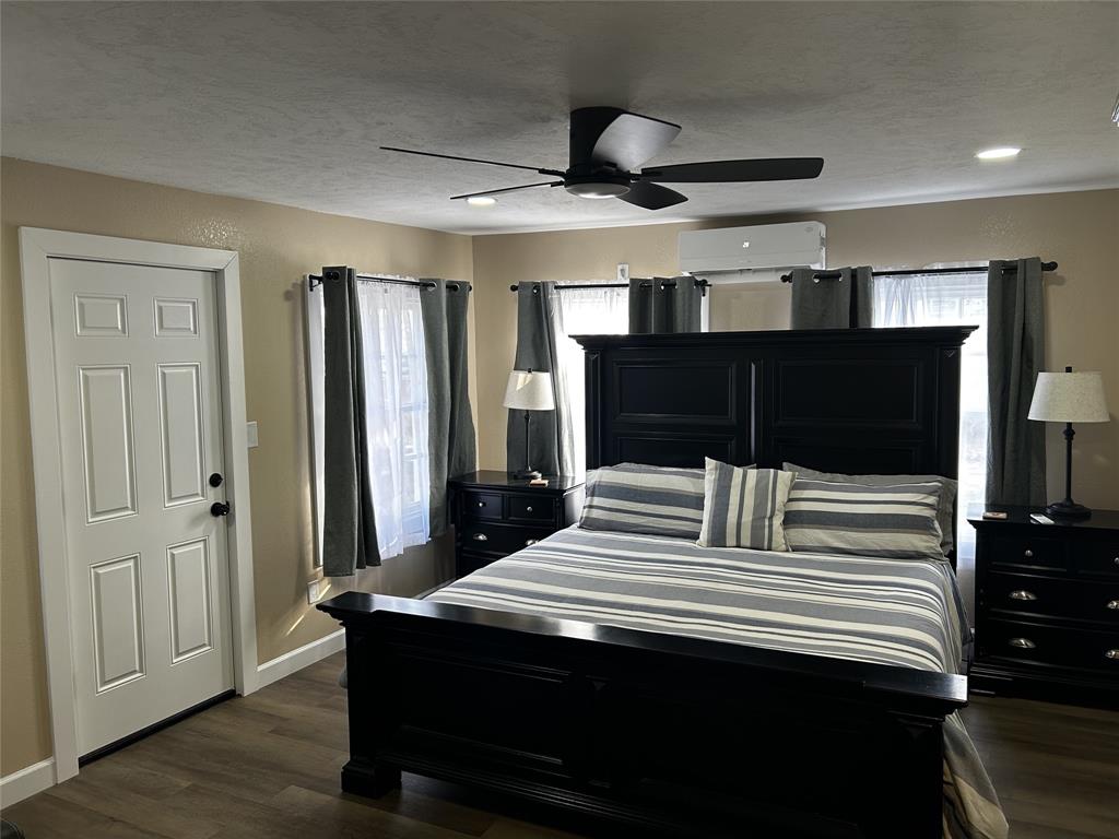 908 West Chestnut Street Denison, TX 75020 - Photo 12 of 19 a bedroom with a bed and wooden floor