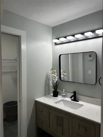 a bathroom with a double vanity sink and a mirror