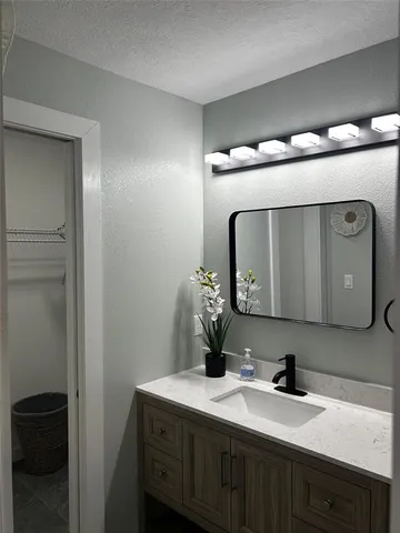 a bathroom with a double vanity sink and a mirror