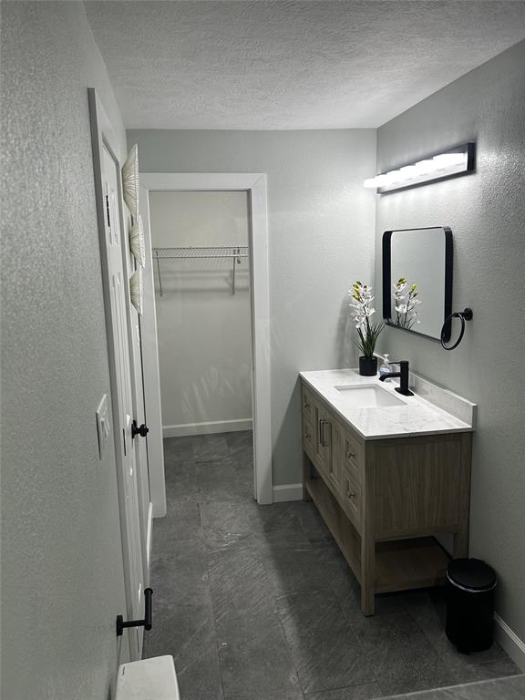 908 West Chestnut Street Denison, TX 75020 - Photo 16 of 19 a bathroom with a double vanity sink and a mirror