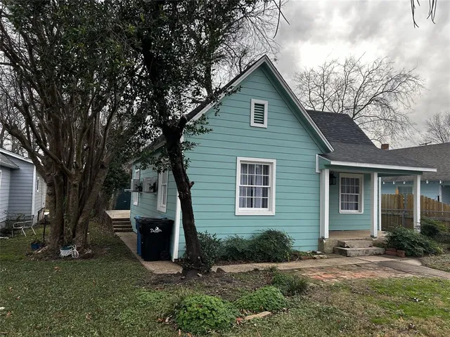 a view of a backyard with a large tree