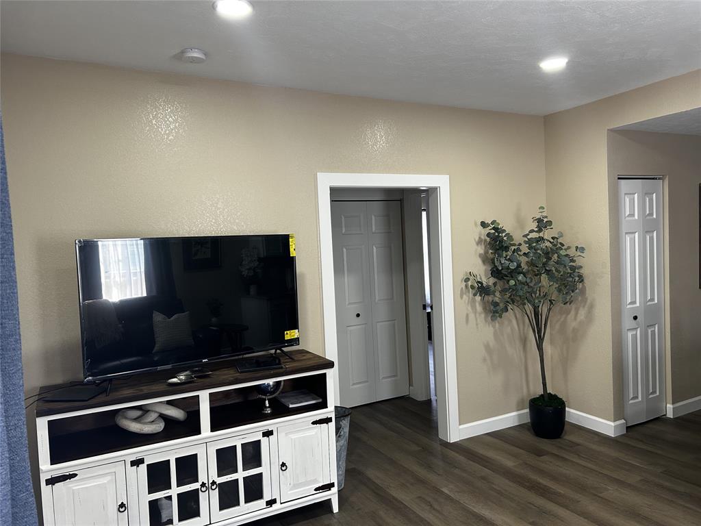 908 West Chestnut Street Denison, TX 75020 - Photo 4 of 19 a living room with flat screen tv and floor to ceiling window