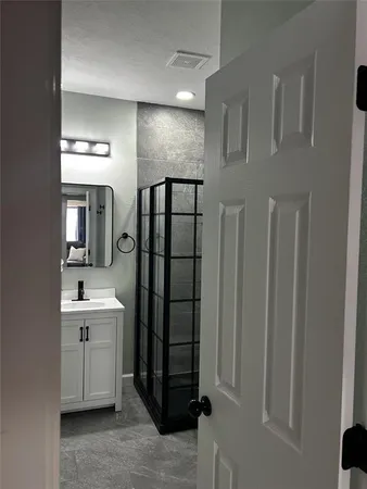 a bathroom with a double vanity sink and mirror
