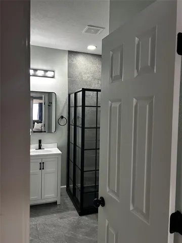 a bathroom with a double vanity sink and mirror