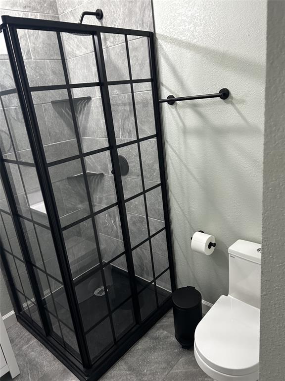 908 West Chestnut Street Denison, TX 75020 - Photo 9 of 19 a white toilet sitting next to a shower