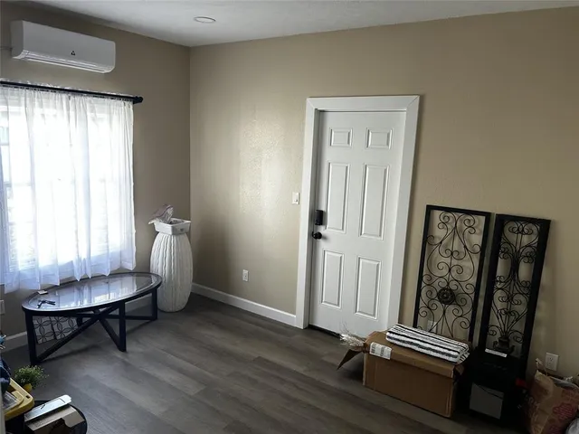 a view of a room with lounge chair and windows