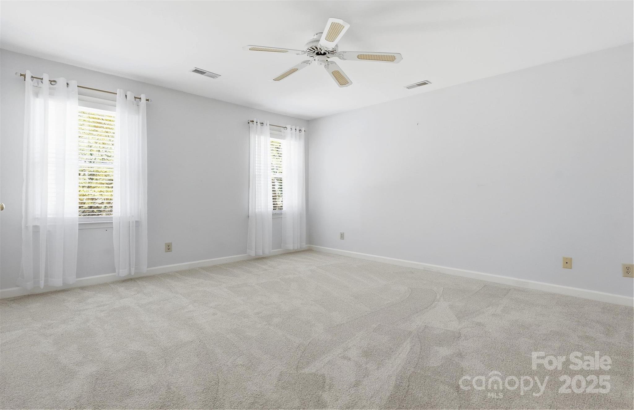 2621 Brightmoor Ridge Drive Matthews, NC 28105 - Photo 12 of 24 an empty room with windows and ceiling fan