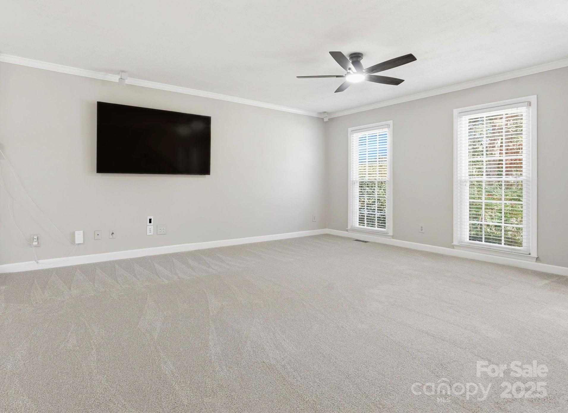 2621 Brightmoor Ridge Drive Matthews, NC 28105 - Photo 7 of 24 a view of an empty room with a flat screen tv