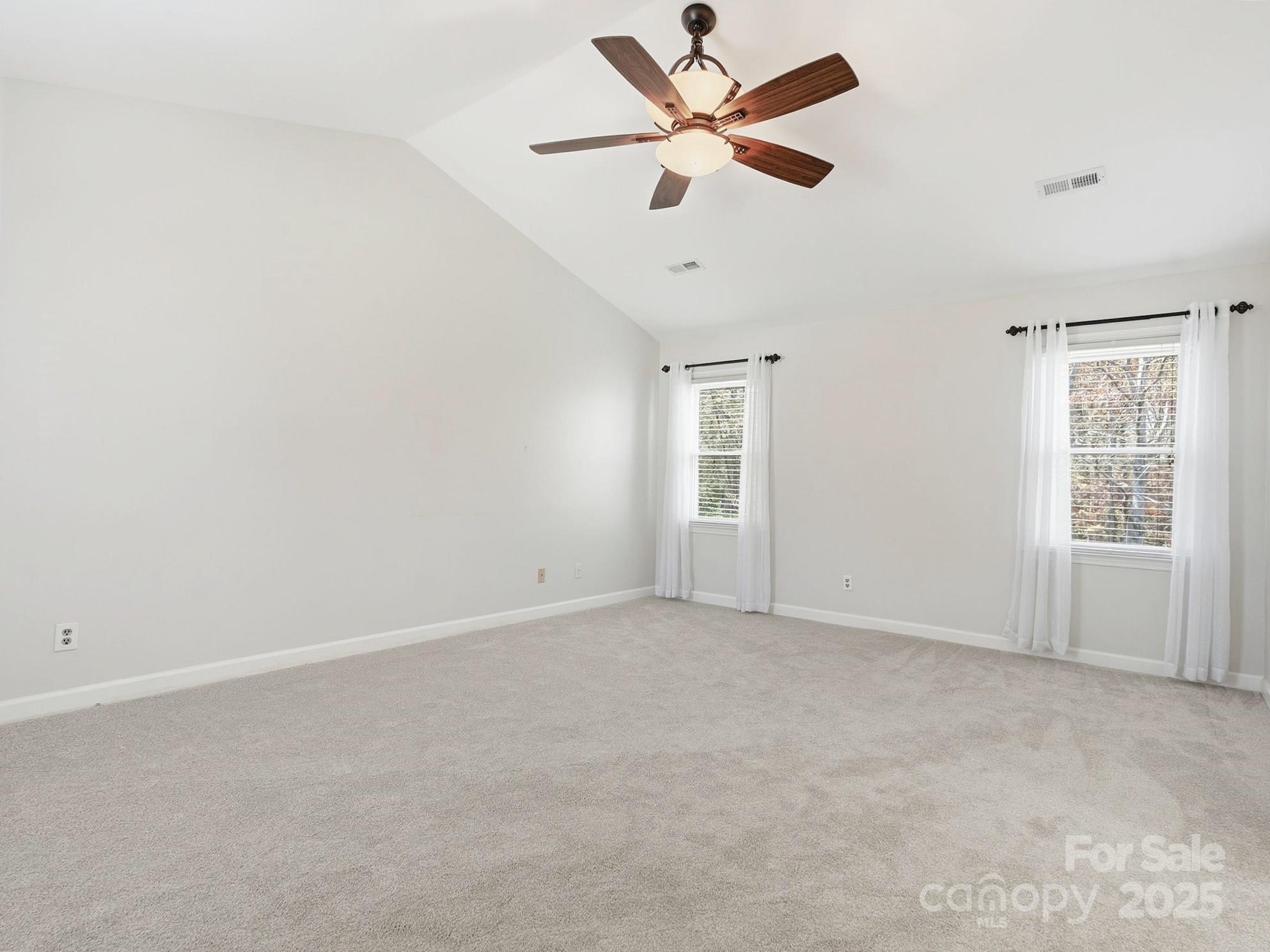 2621 Brightmoor Ridge Drive Matthews, NC 28105 - Photo 8 of 24 an empty room with a window and a fan