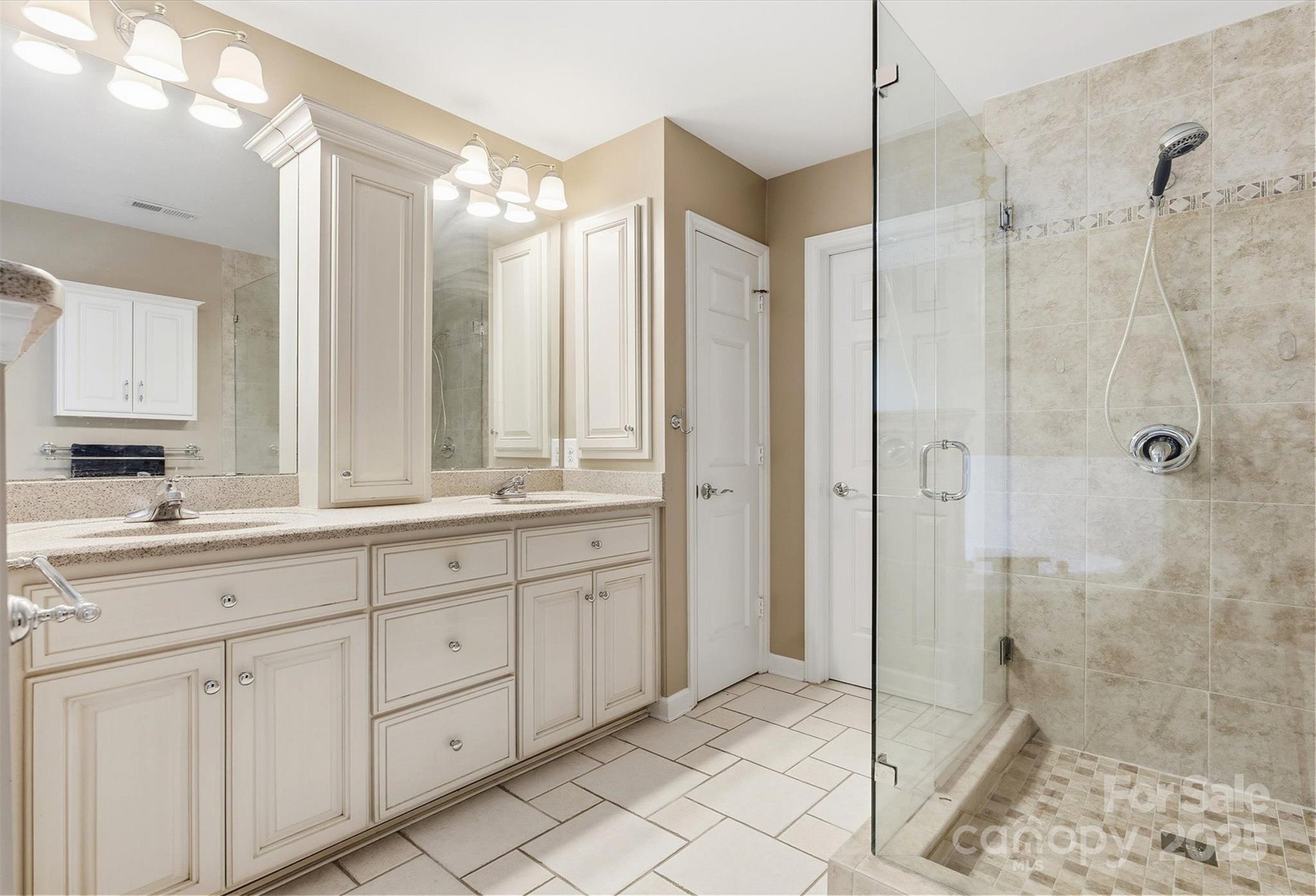 2621 Brightmoor Ridge Drive Matthews, NC 28105 - Photo 9 of 24 a bathroom with a shower sink and mirror
