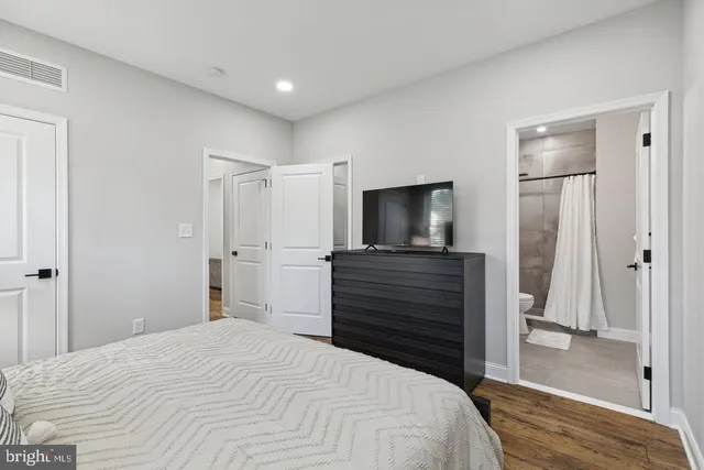 a bedroom with a bed and a flat screen tv