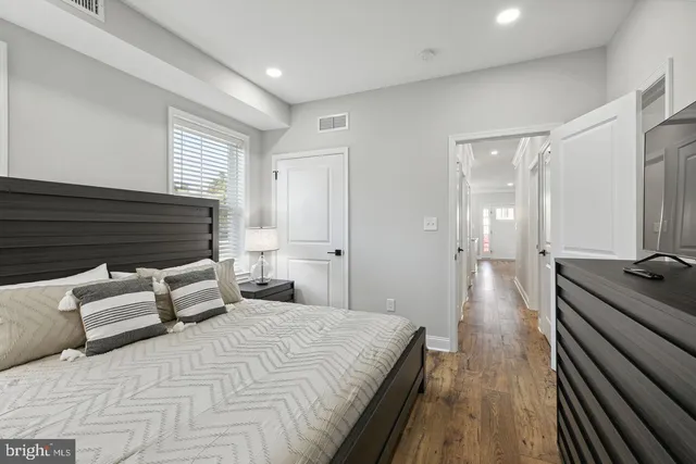 a bedroom with a bed and wooden floor