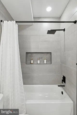 a bathroom with a bathtub and a shower