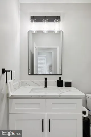 a bathroom with a sink vanity and a mirror