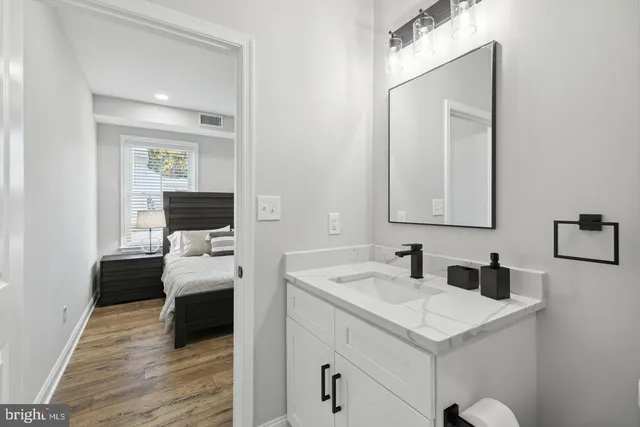 a en suite bathroom with a toilet sink and mirror