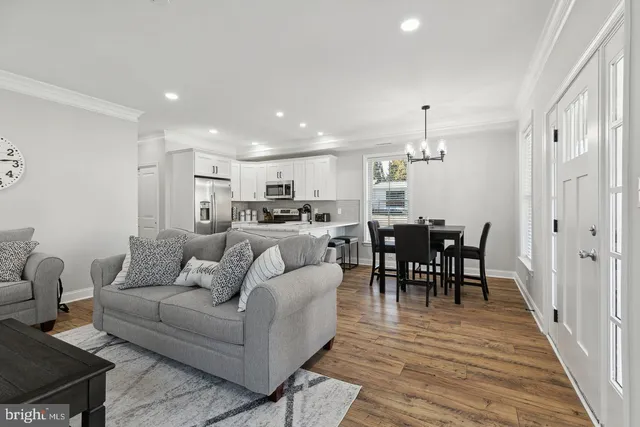 a living room with furniture kitchen view and a dining table