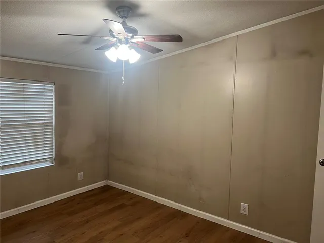 a room with a fan and a window