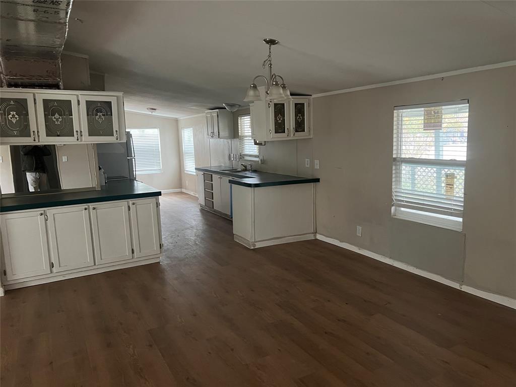 4654 County Road 1078 Princeton, TX 75407 - Photo 3 of 8 a kitchen with granite countertop a stove a sink and a microwave