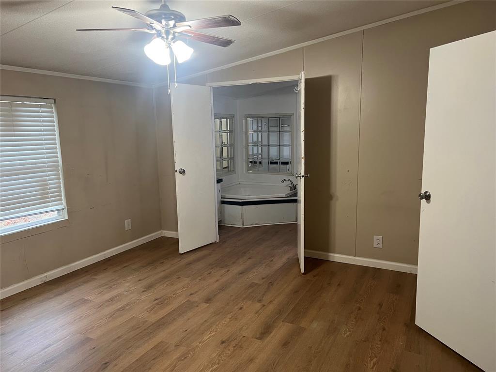 4654 County Road 1078 Princeton, TX 75407 - Photo 4 of 8 wooden floor in an empty room with a window