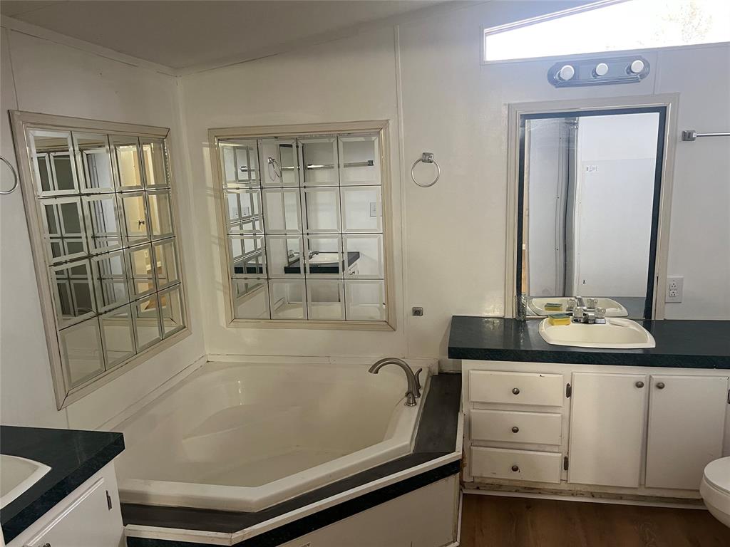 4654 County Road 1078 Princeton, TX 75407 - Photo 5 of 8 a bathroom with a sink and a mirror