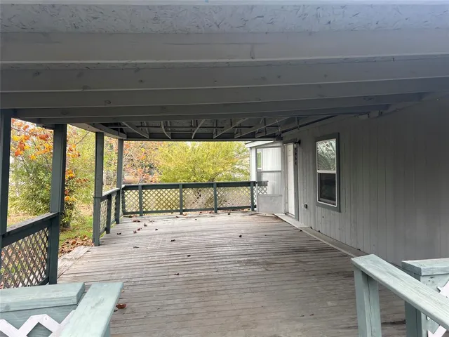 a view of a porch with wooden floor and outdoor space
