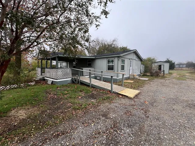 a view of a house with a yard and sitting area