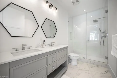 a bathroom with a sink a mirror and a window