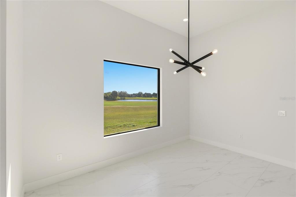 17 Long Meadow Road Rotonda West, FL 33947 - Photo 17 of 37 a view of a room with a fan and a window